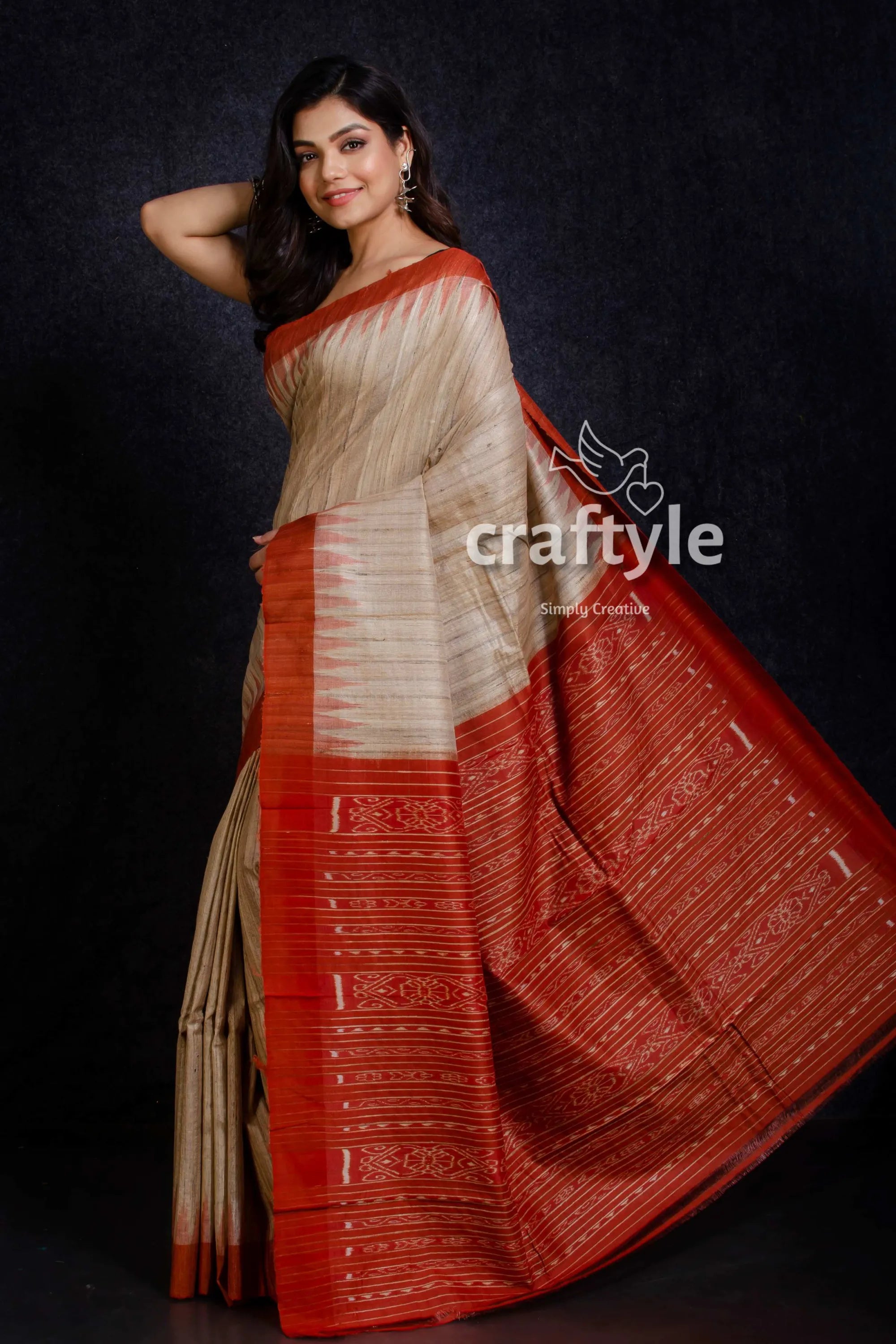 Beige and fire orange sambalpuri ikat tussar ghicha silk saree woman wears traditional indian saree 3