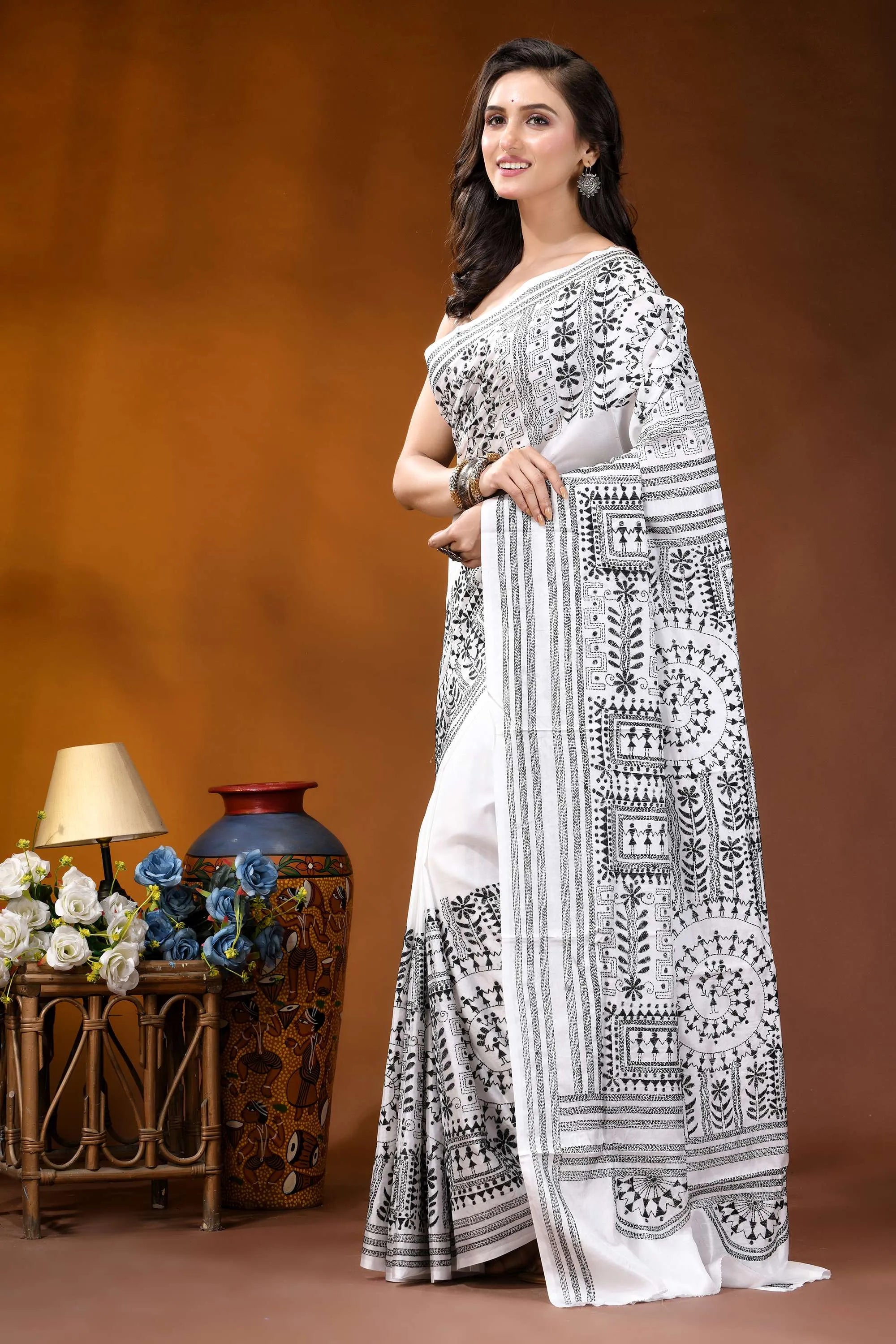 Black thread warli motif hand embroidered silk kantha saree in white woman wears white saree intricate 3