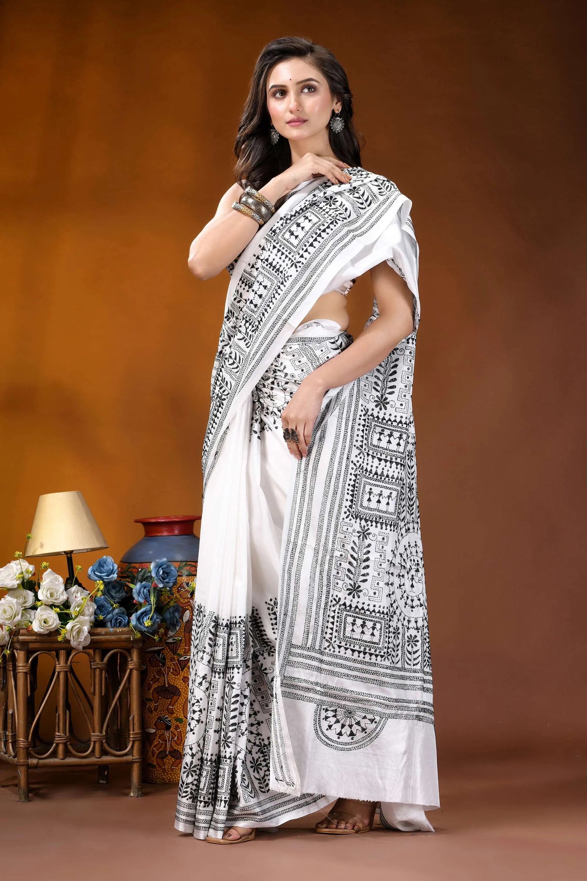 Black thread warli motif hand embroidered silk kantha saree in white woman wears white saree intricate 4