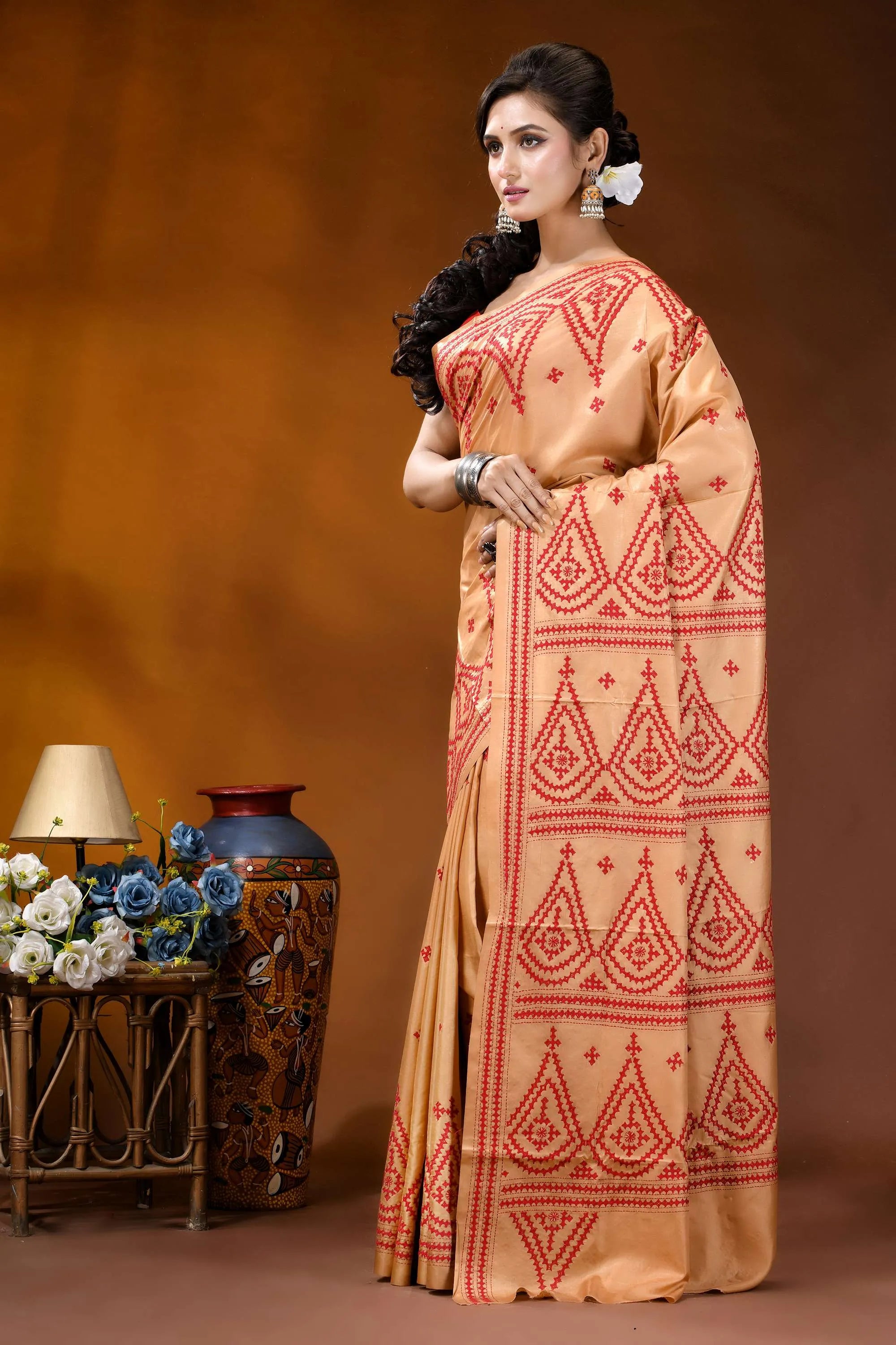 Burning sand ethnic motif hand embroidered silk kutch work saree woman wears peach-colored saree intricate 3