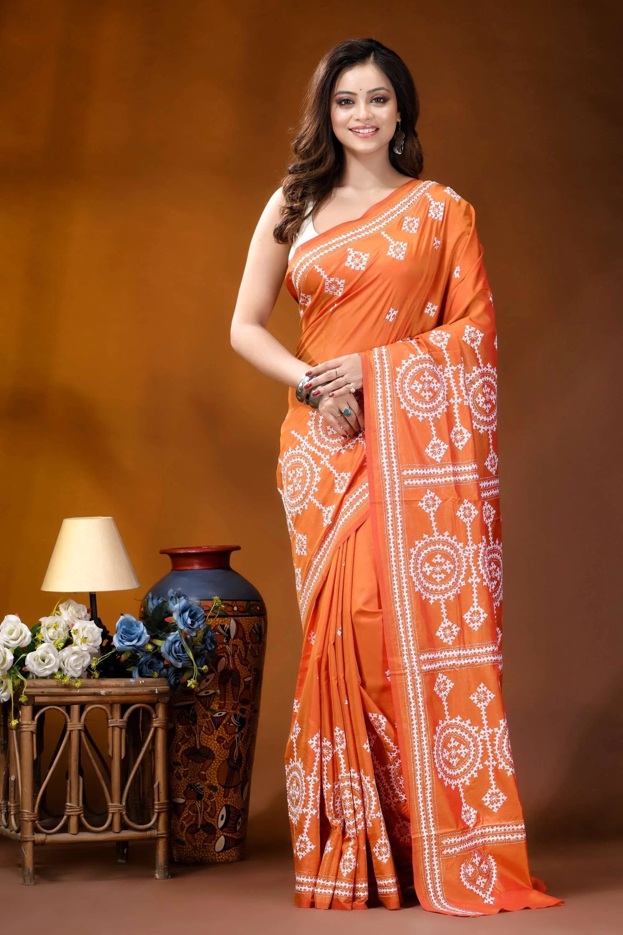 Circular motif hand embroidered silk kutch work saree in orange vibrant orange saree intricate white 1