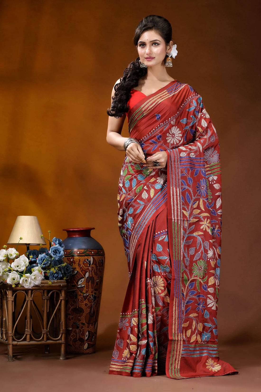 Handcrafted pale carmine silk kantha saree in multicolor floral motif woman wears rich red silk 2