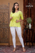 Lemon yellow cotton printed top with three quarter sleeves woman yellow patterned white leggings 1