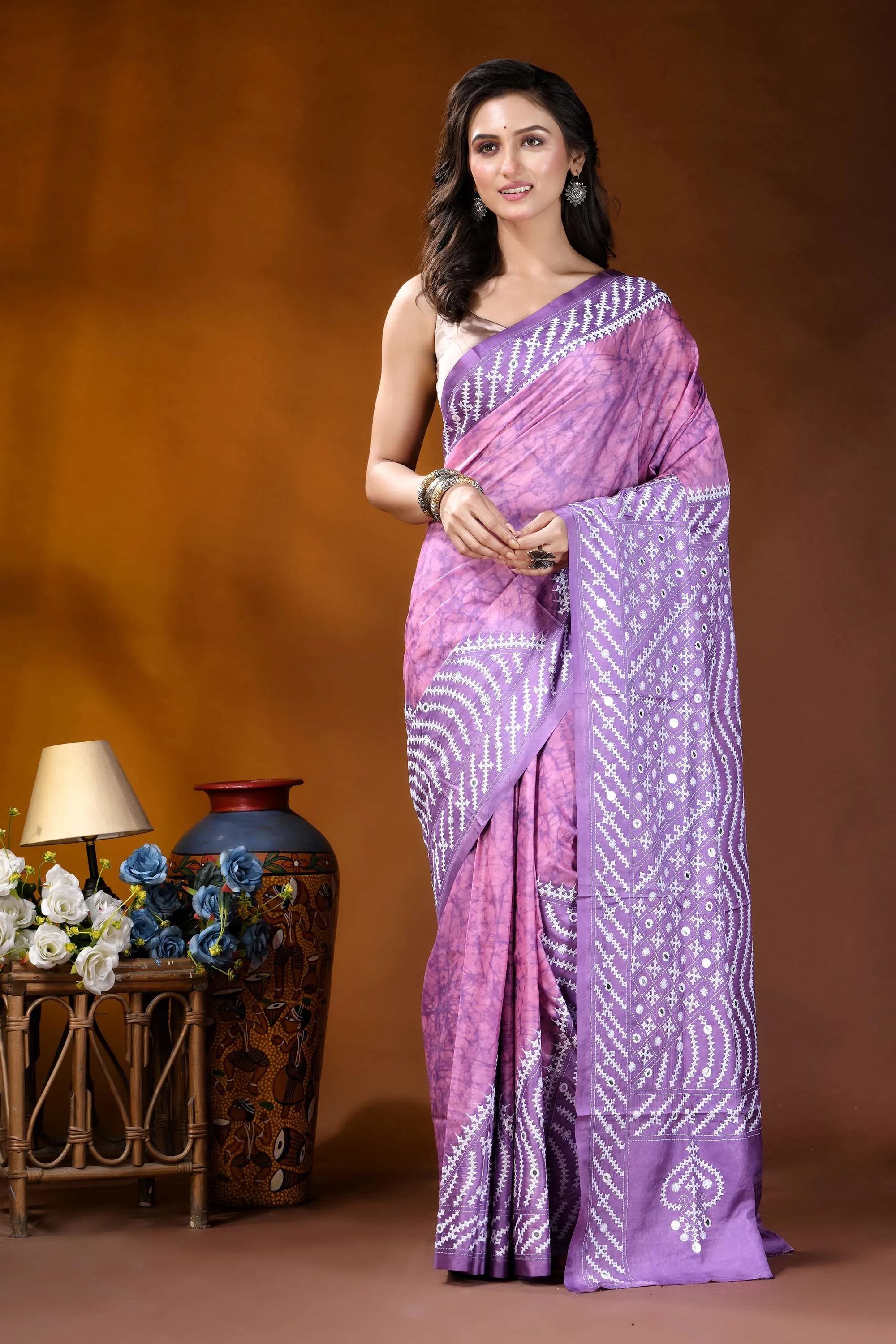 Mirror work geometric pattern hand batik gujarati stitch pink lavender dyed silk saree woman wears vibrant purple saree