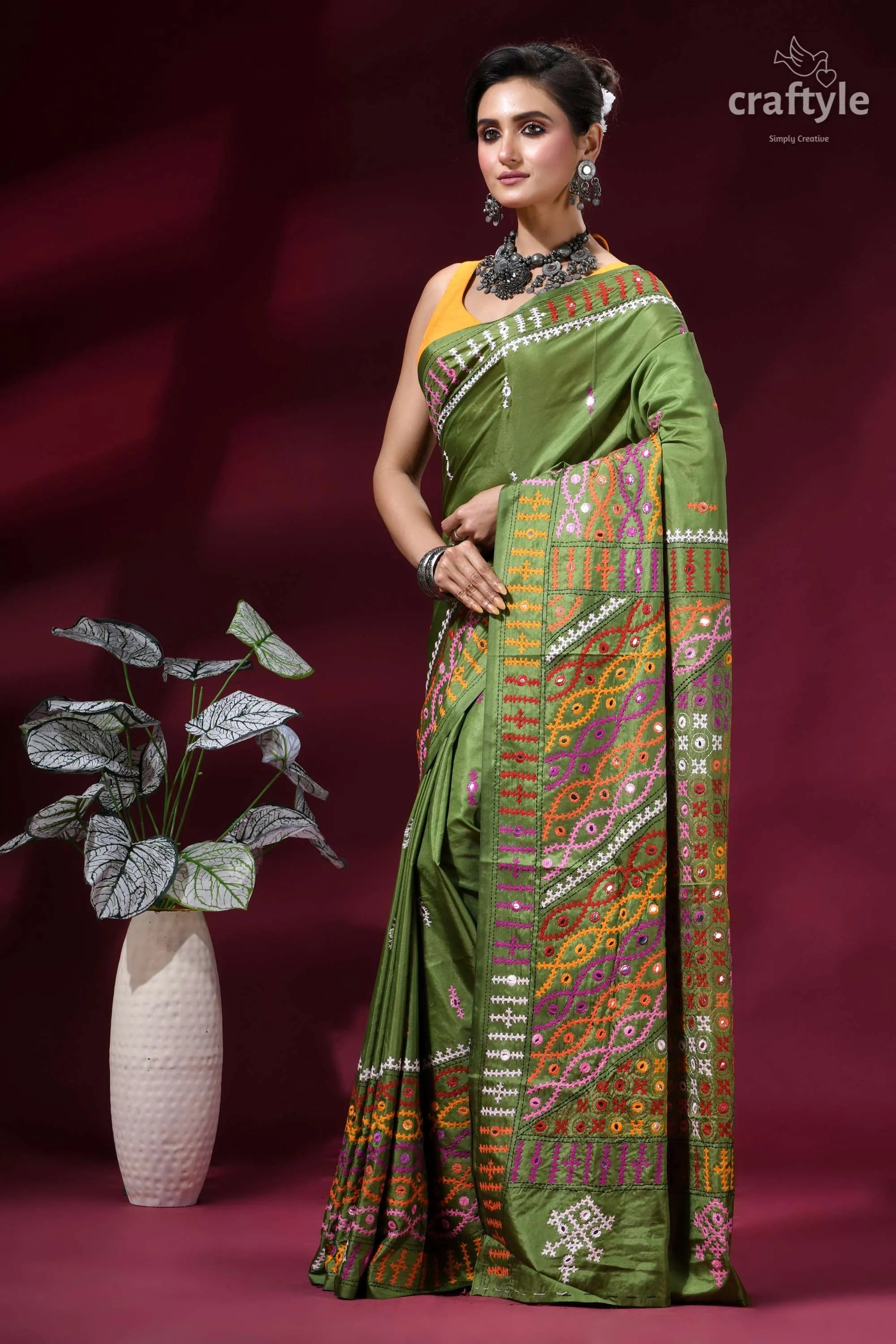 Muddy green dual-tone kutch work silk saree with mirror detailing vibrant olive green saree intricate 3