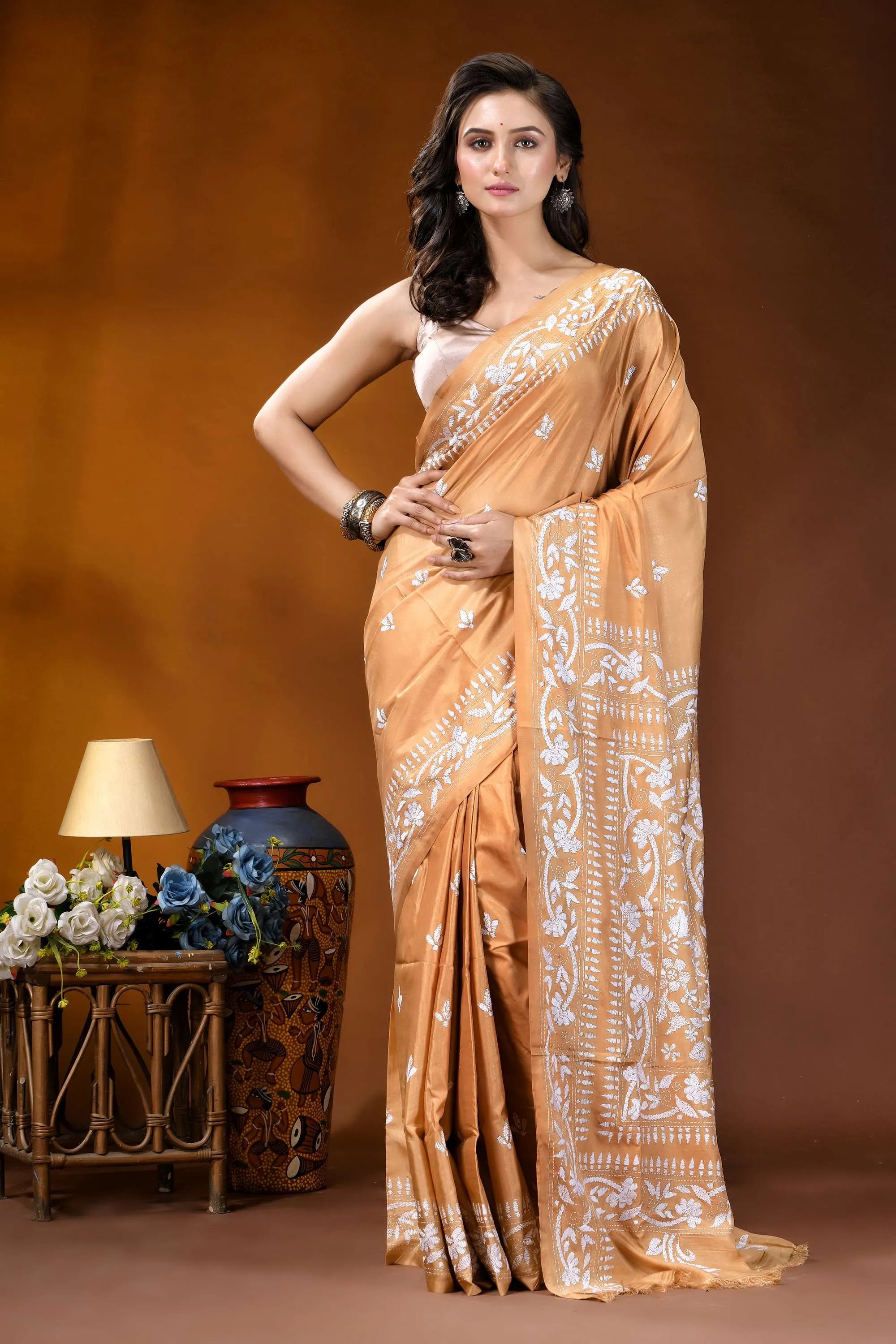 Sand brown white thread floral design handcrafted silk kantha saree woman wears golden-orange silk saree 1