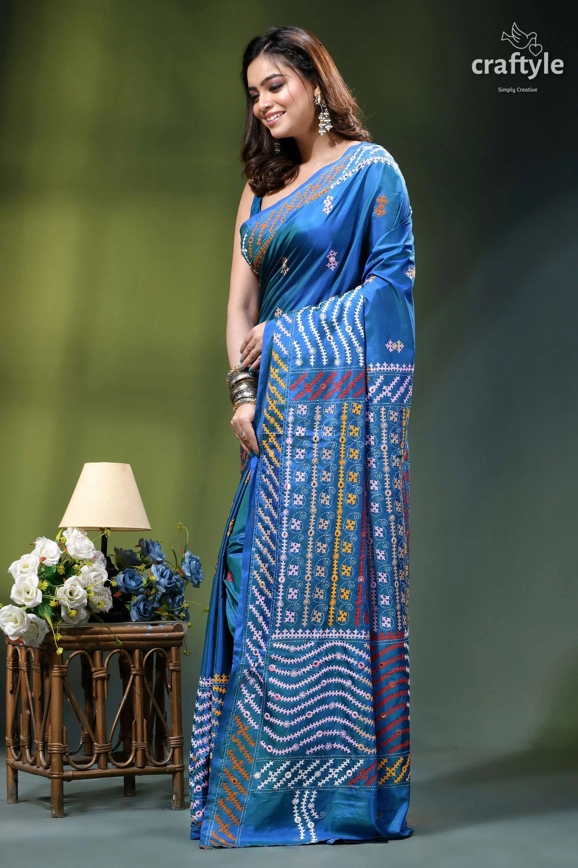 True blue dual-tone gujrati stitch silk saree with mirror detailing woman wears vibrant blue silk 3