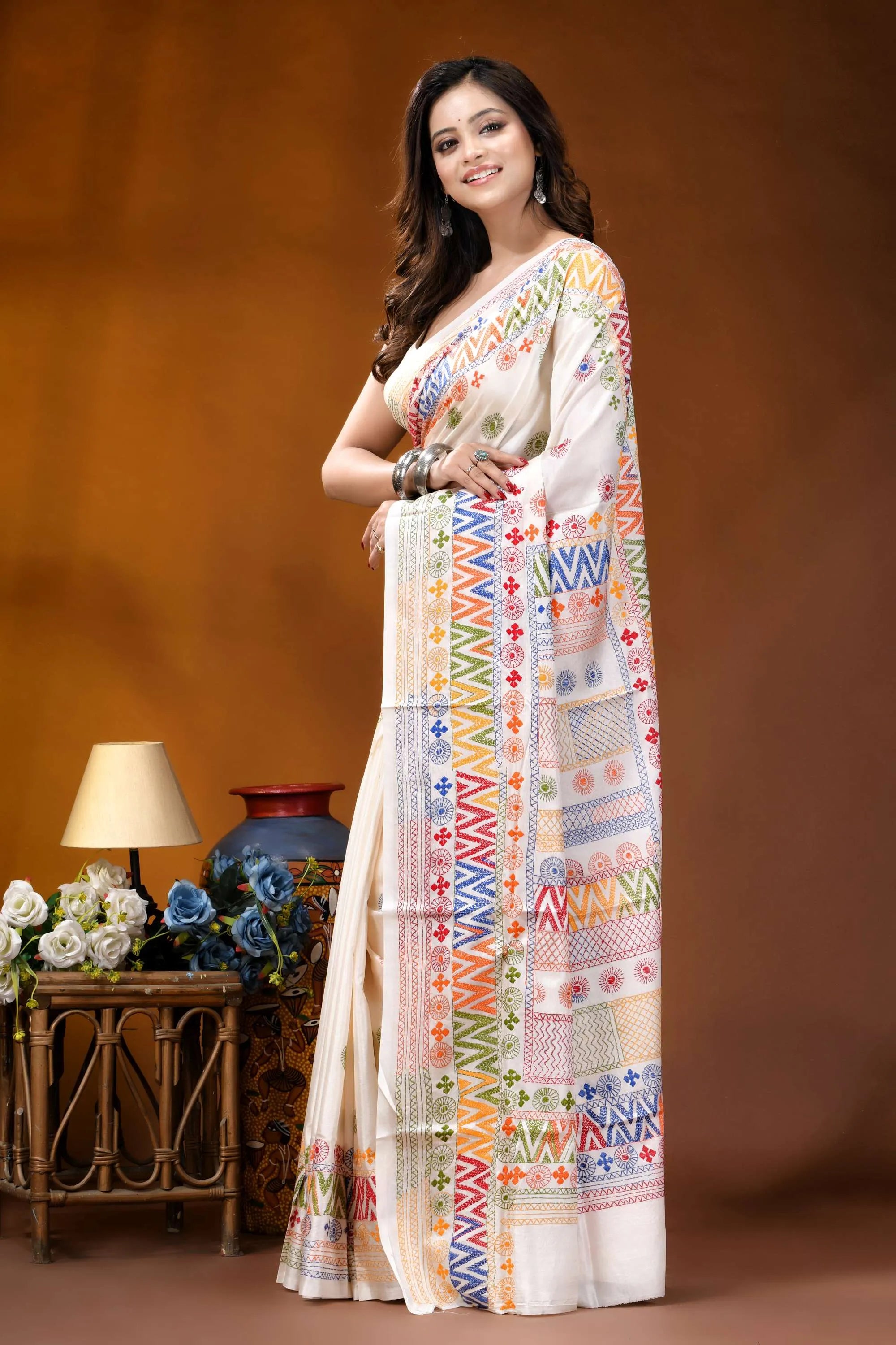 White multi-thread geometric motif hand embroidered lambani silk saree woman wears off-white silk saree 3