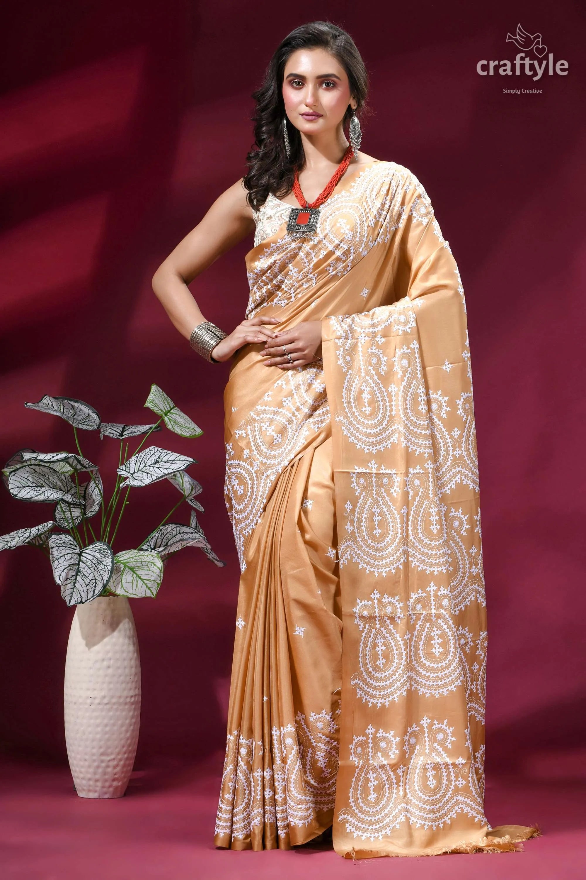 White thread hand gujrati embroidery silk saree in tan color woman wears golden-brown silk saree 1