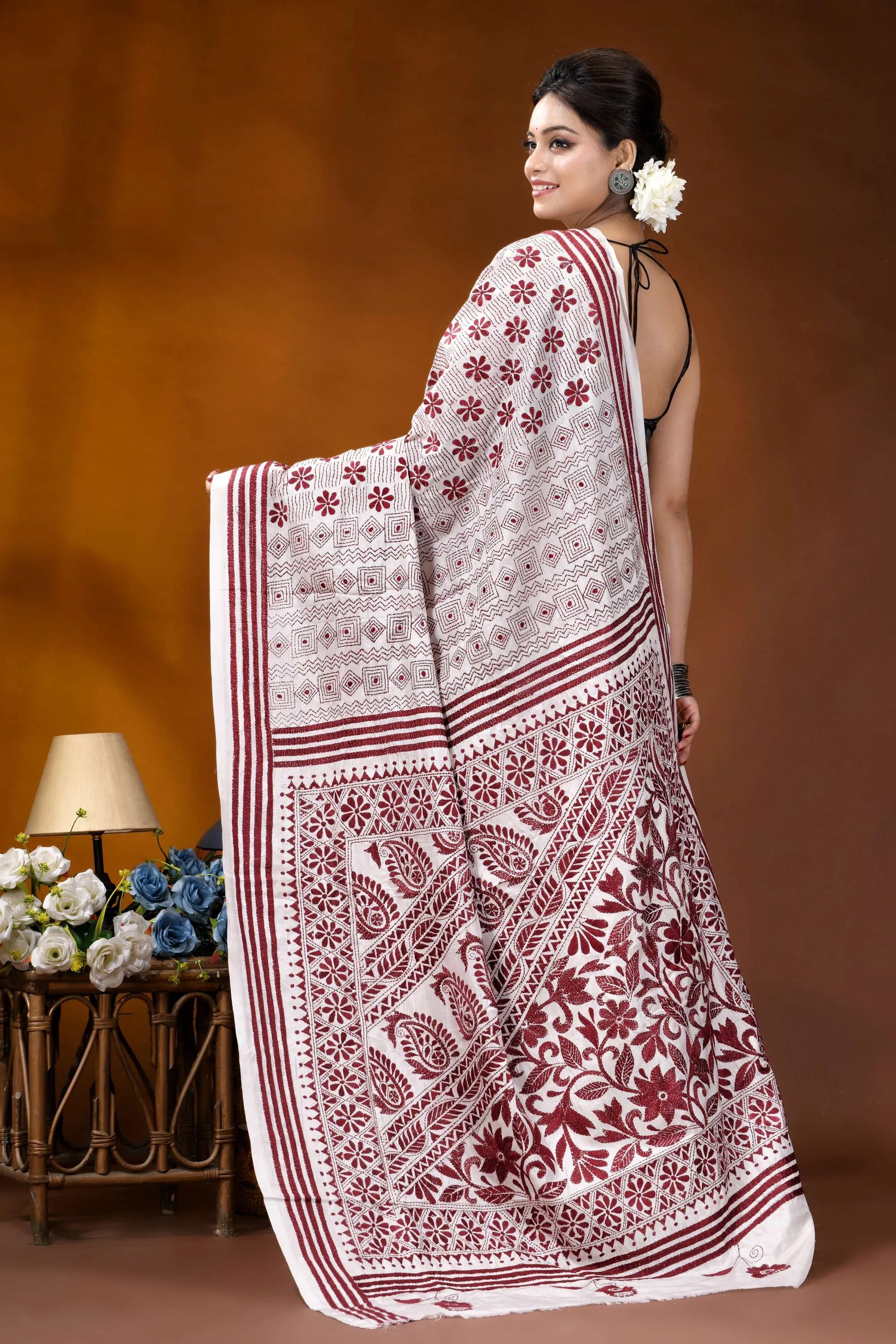 Wine color thread work floral motif handcrafted silk kantha saree in white woman wears white maroon printed 5