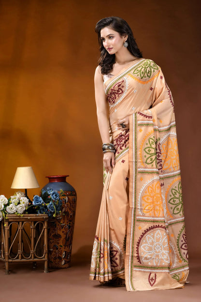 Beige multi-thread floral motif kutch embroidery silk saree woman wears peach-colored saree intricate 3