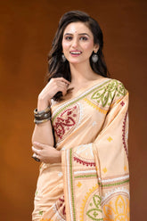 Beige multi-thread floral motif kutch embroidery silk saree woman wears peach-colored silk saree 2