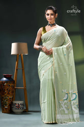 Bird motif handwoven soft cotton jamdani saree in laurel green pale green saree gold accents 1