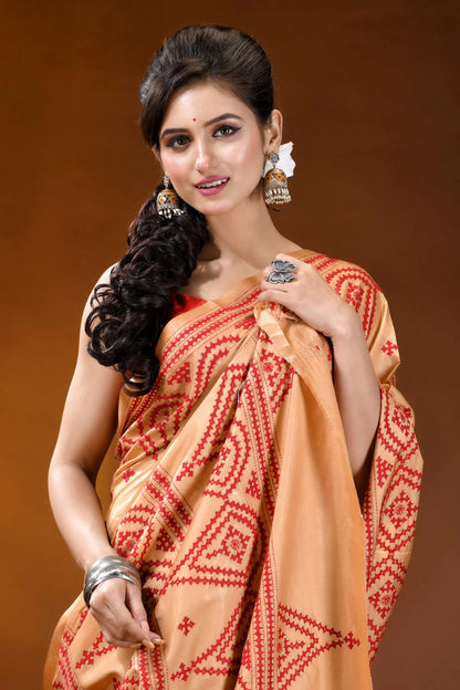 Burning sand ethnic motif hand embroidered silk kutch work saree woman wears peach-colored saree intricate 2