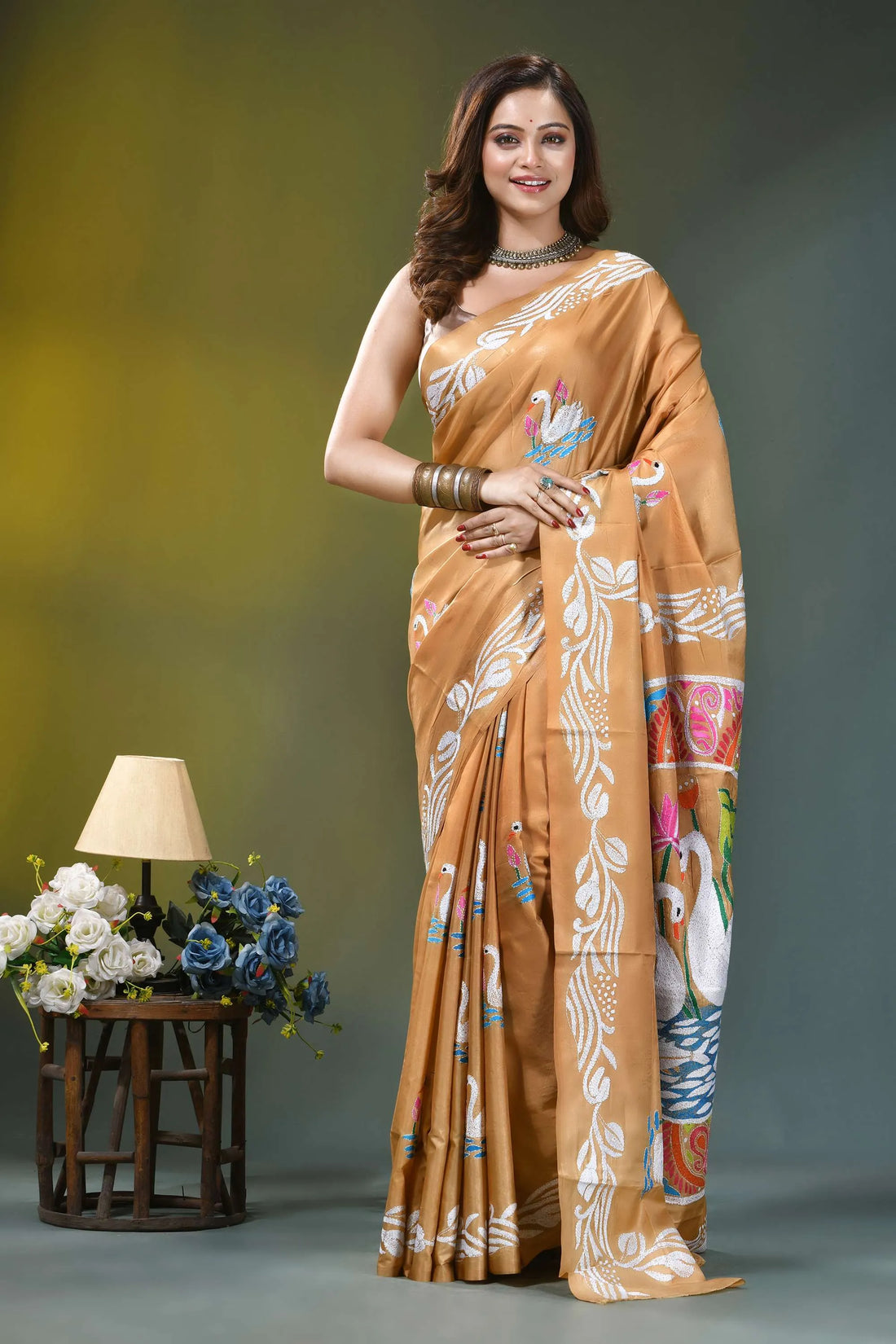 Camel gold multicolor swan design silk kantha saree woman wears golden-orange silk saree 1