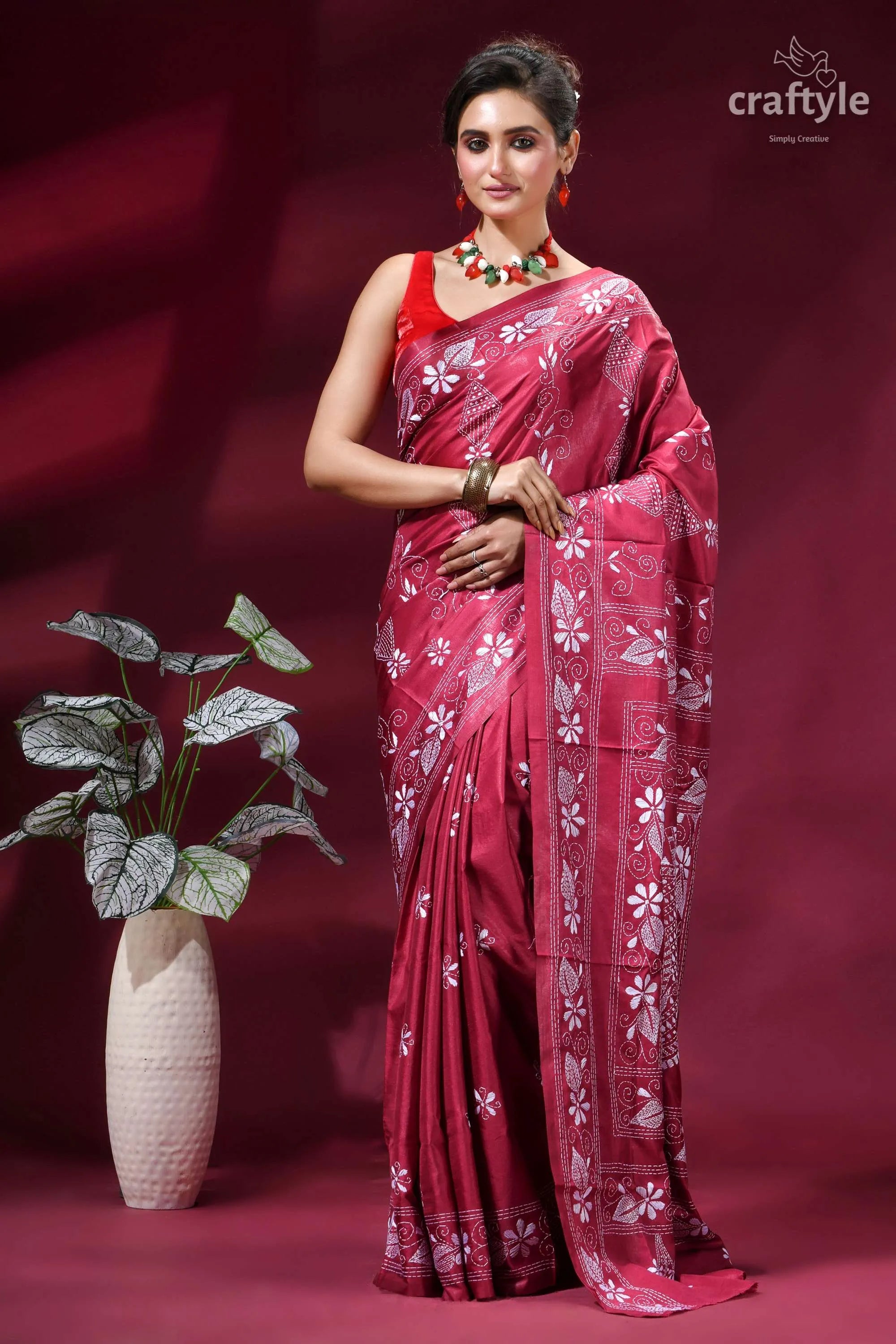 Cerise pink fish motif handcrafted silk kantha stitch saree woman wears vibrant maroon saree 1