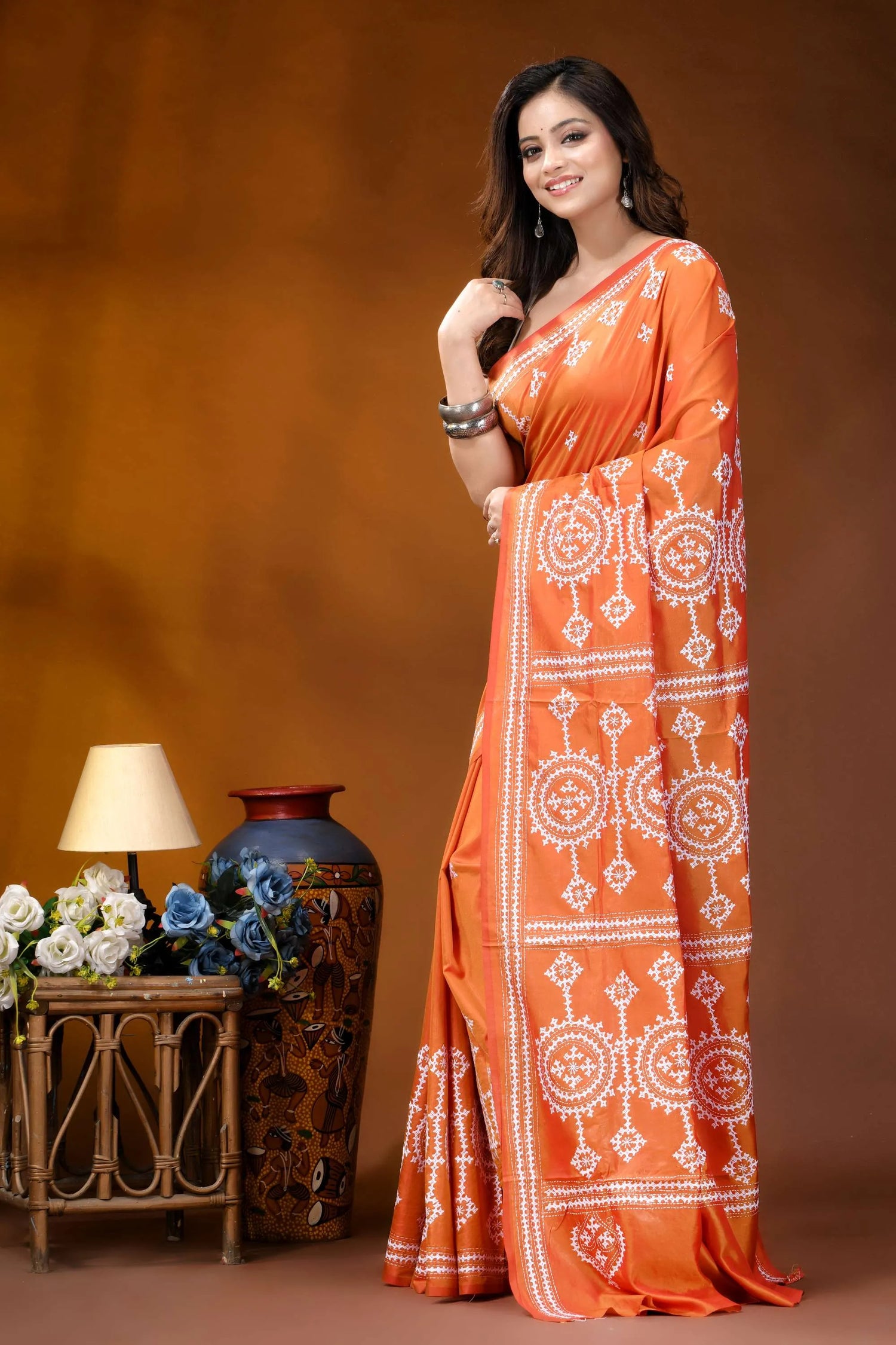 Circular motif hand embroidered silk kutch work saree in orange vibrant orange saree intricate white 3