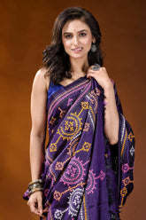 Dark purple multithread circular motif kutch embroidery silk saree woman wears vibrant purple saree 2