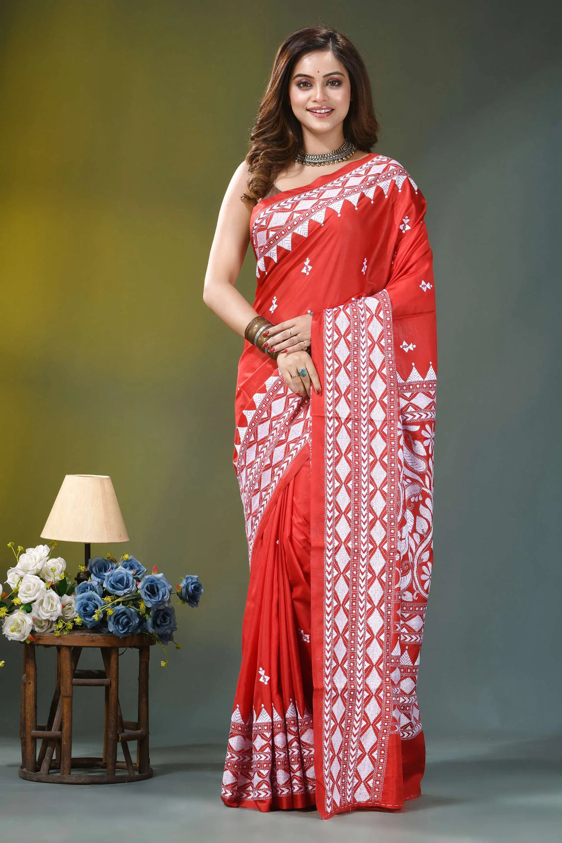 Folk motif vermilion red hand kantha embroidery silk saree vibrant red saree intricate white 1