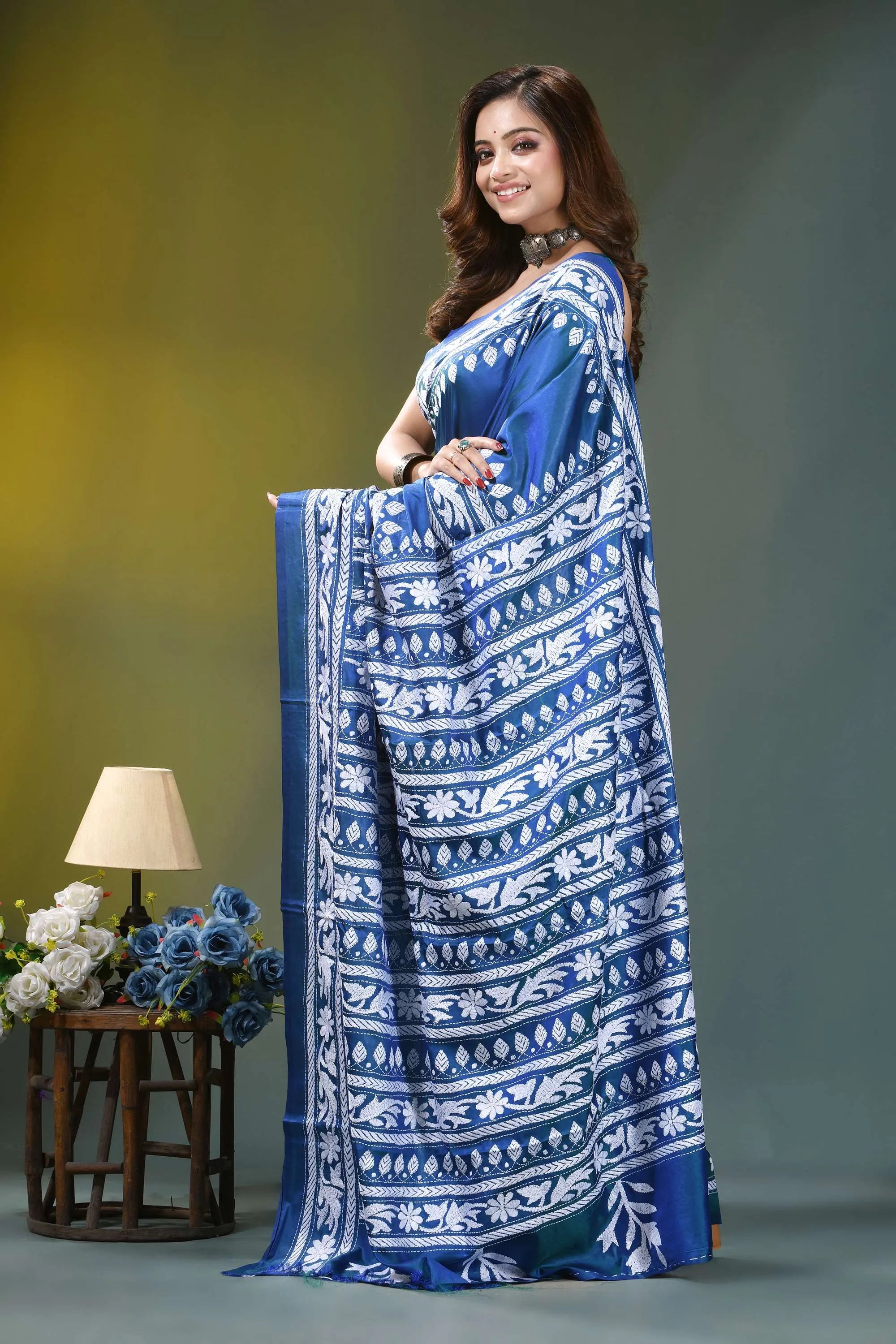 Fun blue handcrafted floral motif silk kantha stitch saree woman wears vibrant blue saree 3