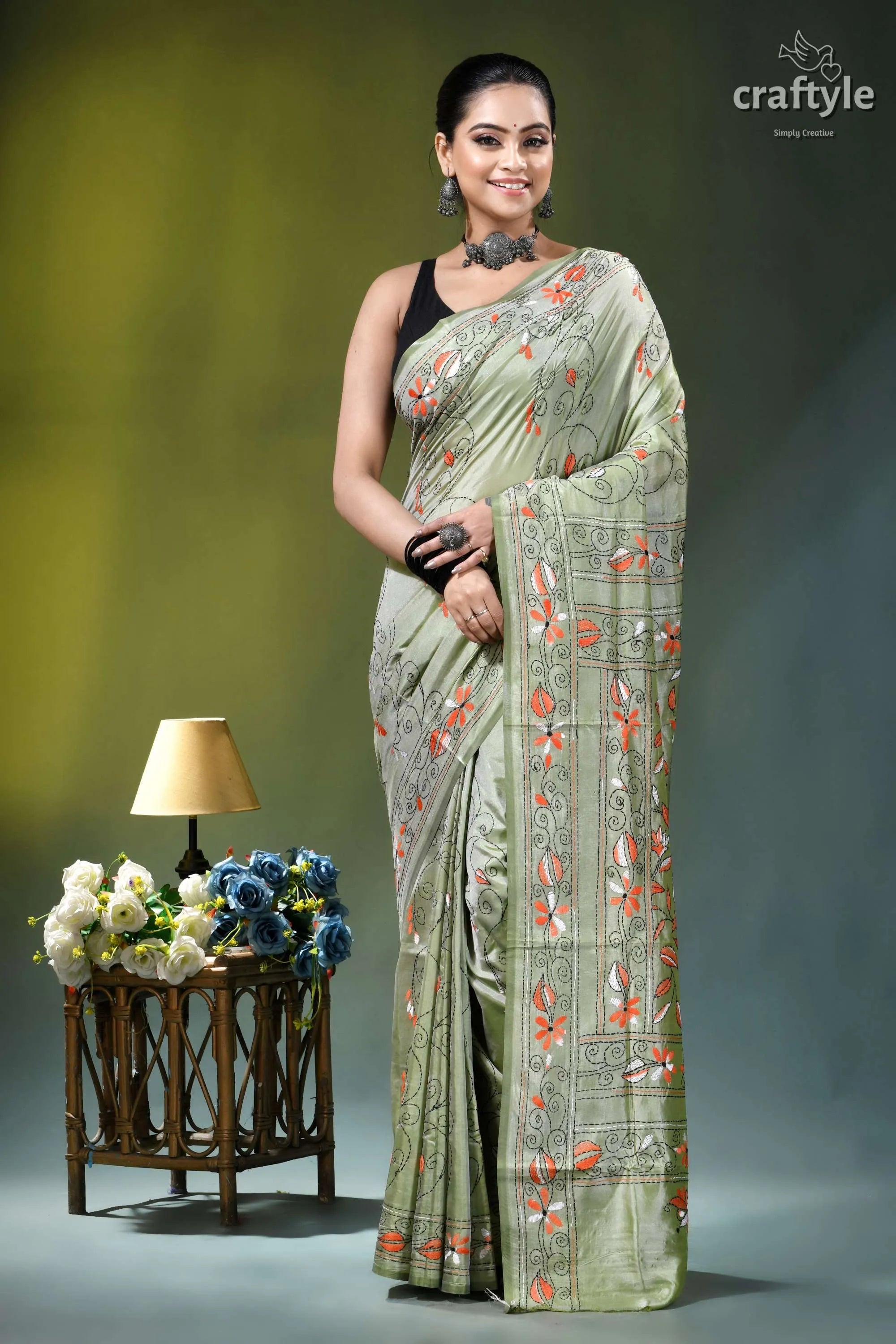 Grayish olive floral motif handmade silk kantha stitch saree woman wears light green silk 1