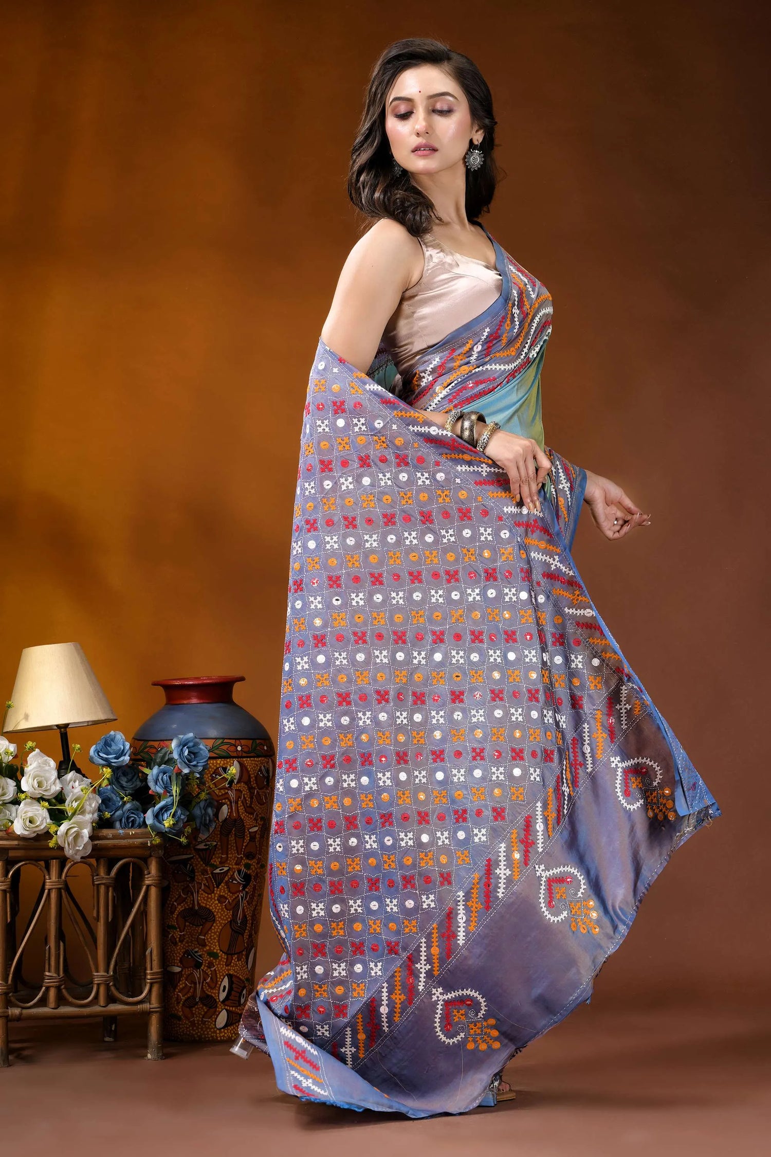Greyish teal multi-thread ethnic design gujarati stitch dyed silk saree - mirror detailing woman wears vibrant