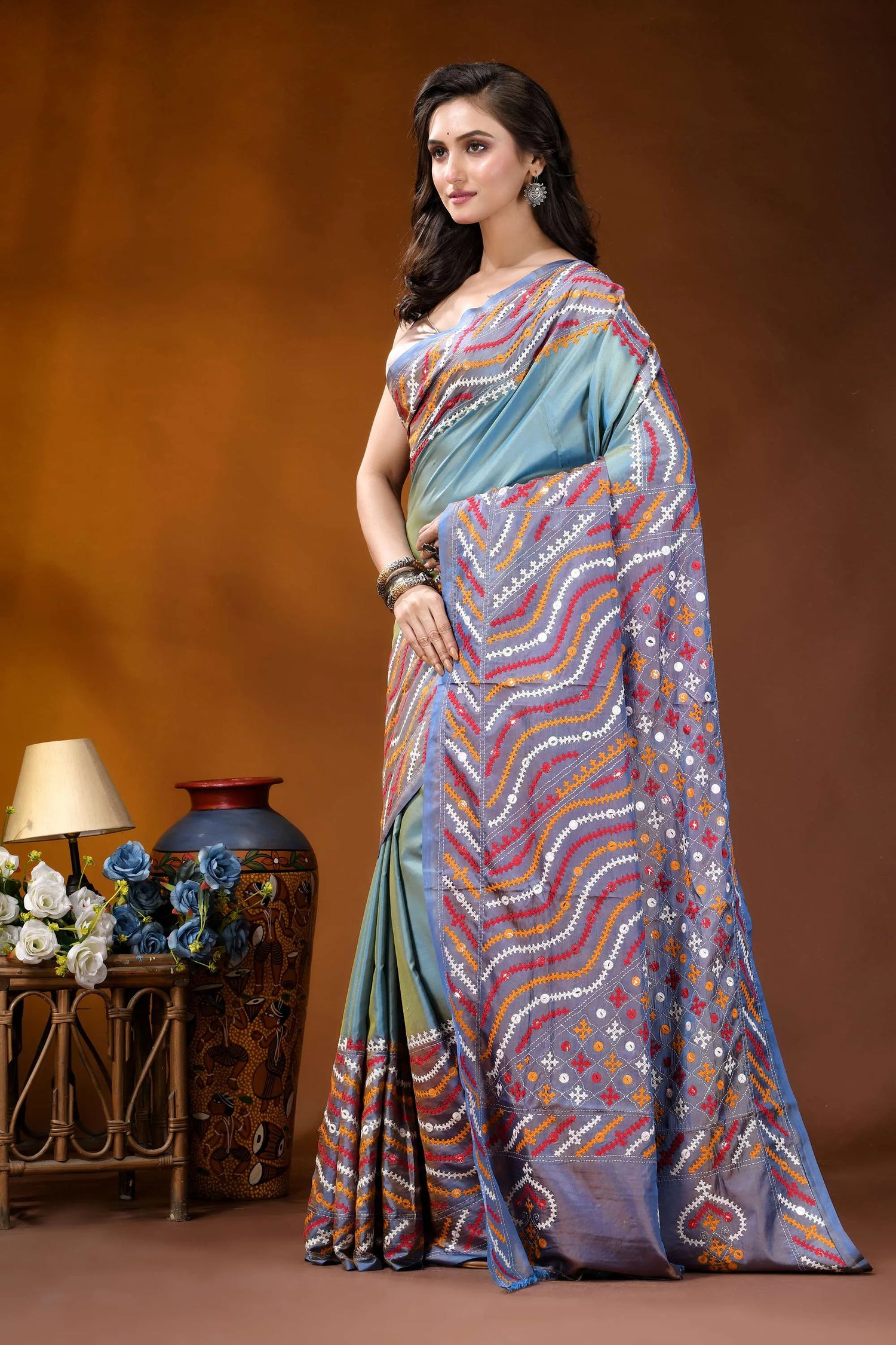 Greyish teal multi-thread ethnic design gujarati stitch dyed silk saree - mirror detailing woman wears light blue