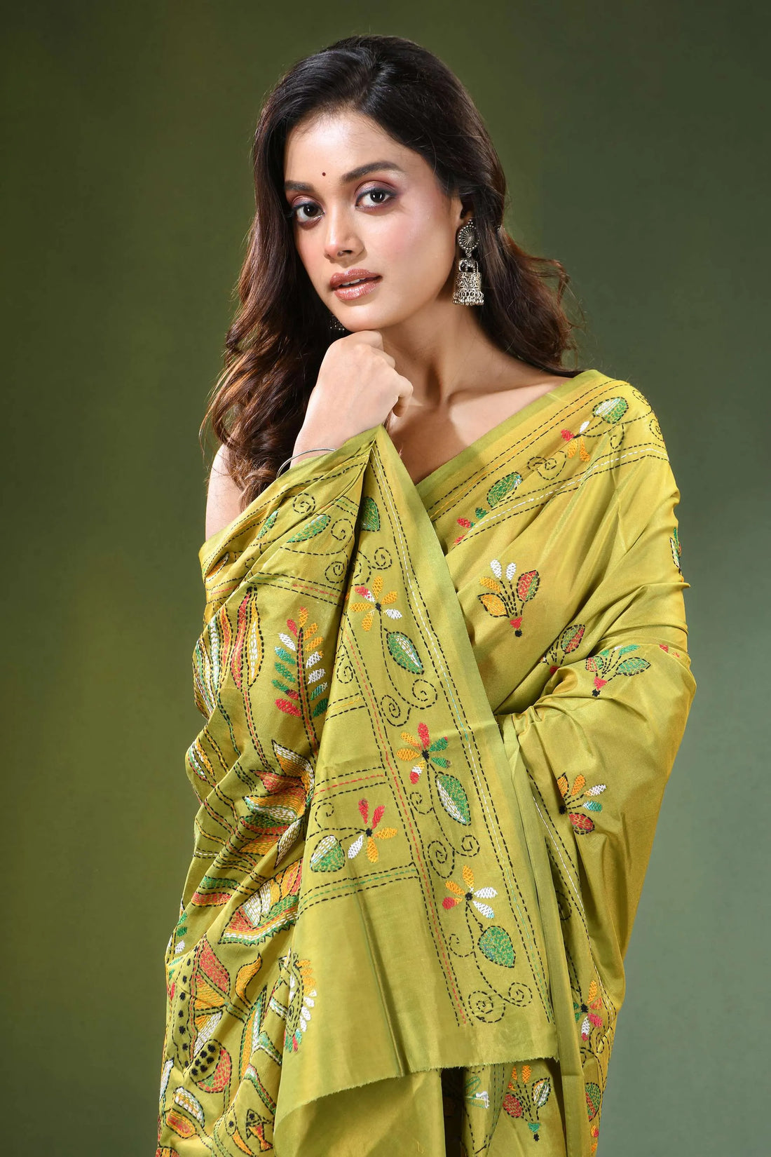 Handcrafted leaf green silk kantha saree with heron and lotus motif woman wears vibrant olive 2