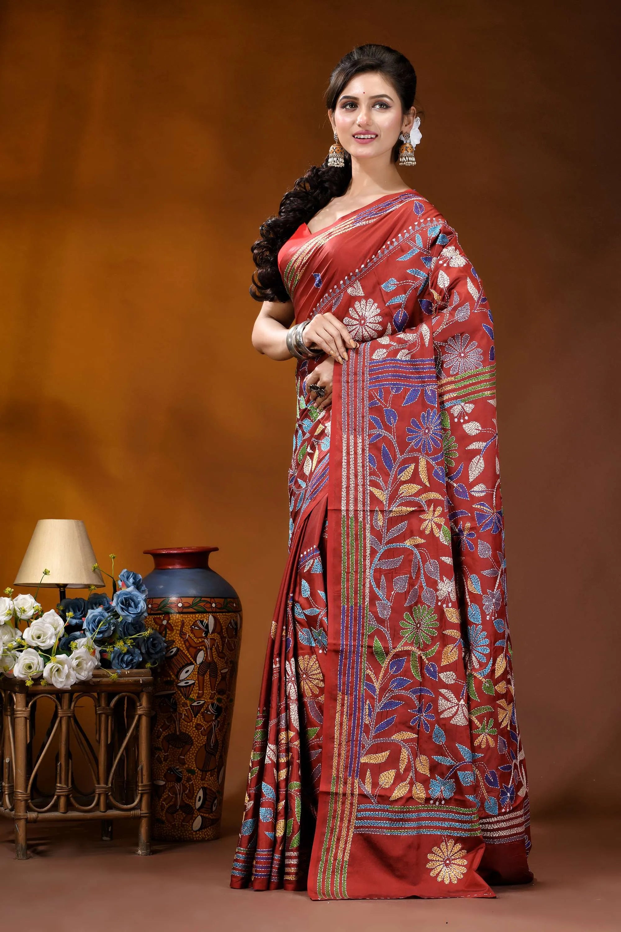 Handcrafted pale carmine silk kantha saree in multicolor floral motif woman wears rich red silk 3