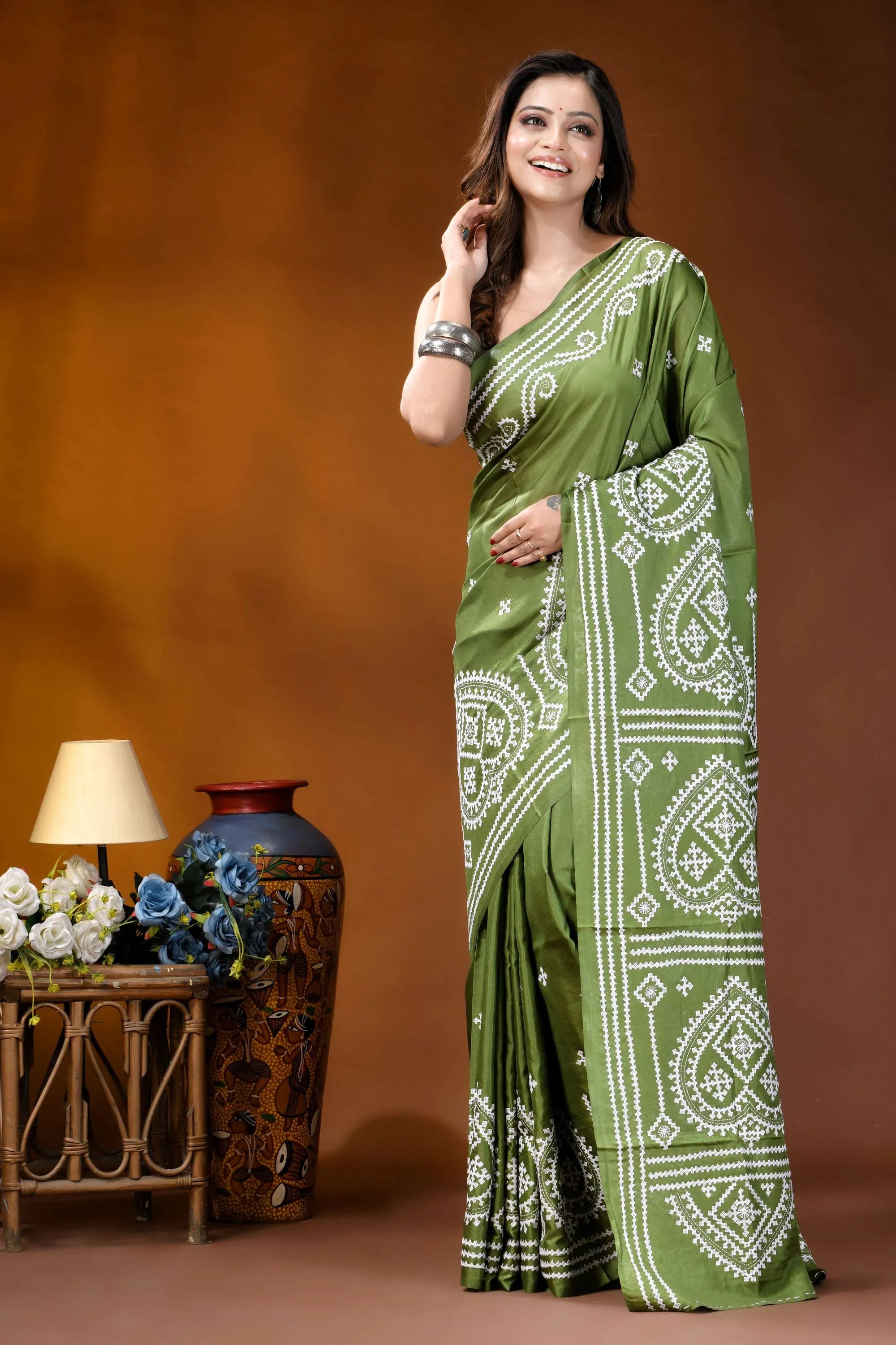 Leaf green ethnic motif hand embroidered gujrati stitch silk saree woman wears vibrant olive green 6