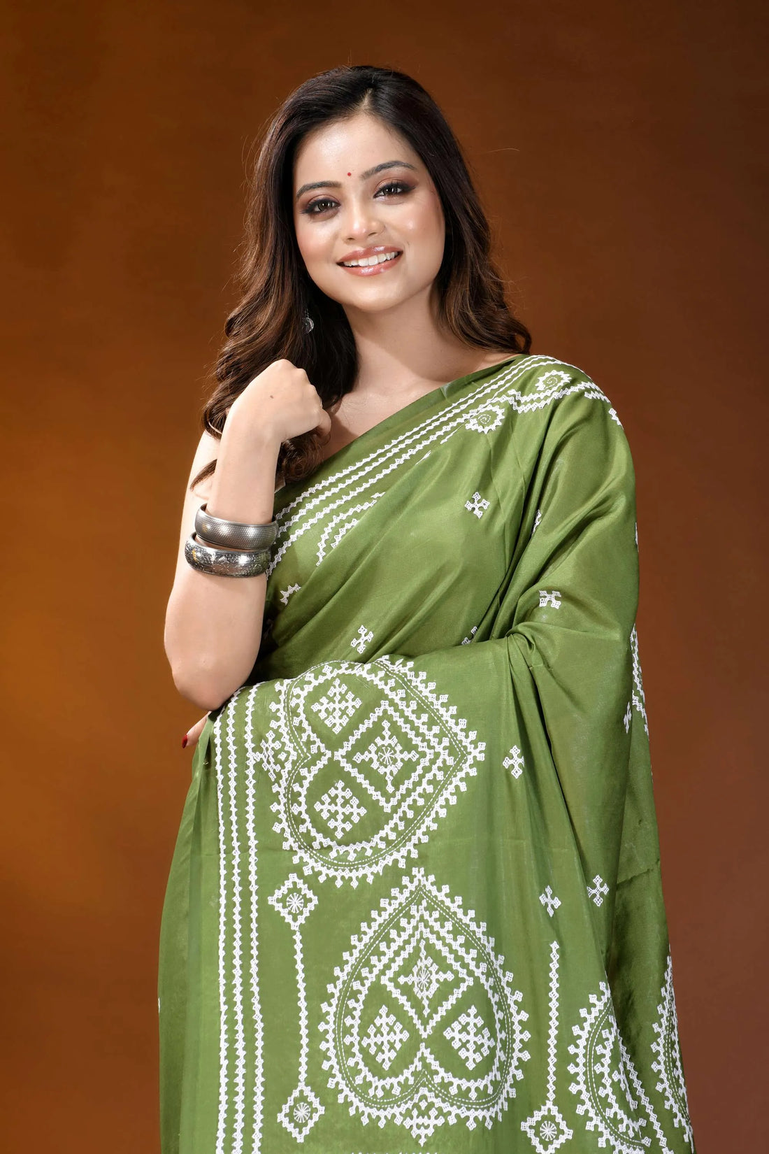 Leaf green ethnic motif hand embroidered gujrati stitch silk saree woman wears vibrant olive green 2