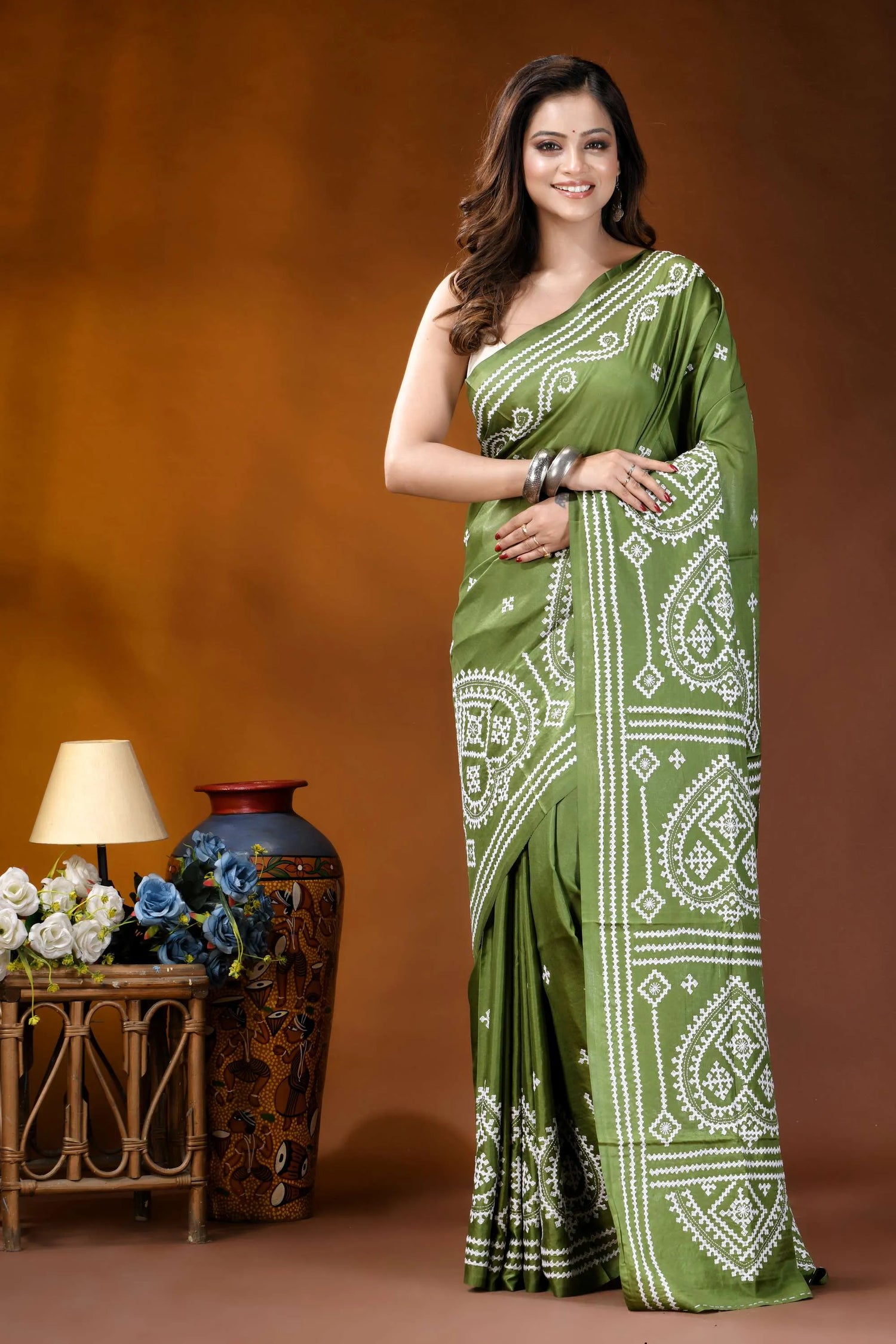 Leaf green ethnic motif hand embroidered gujrati stitch silk saree woman wears vibrant olive green 1