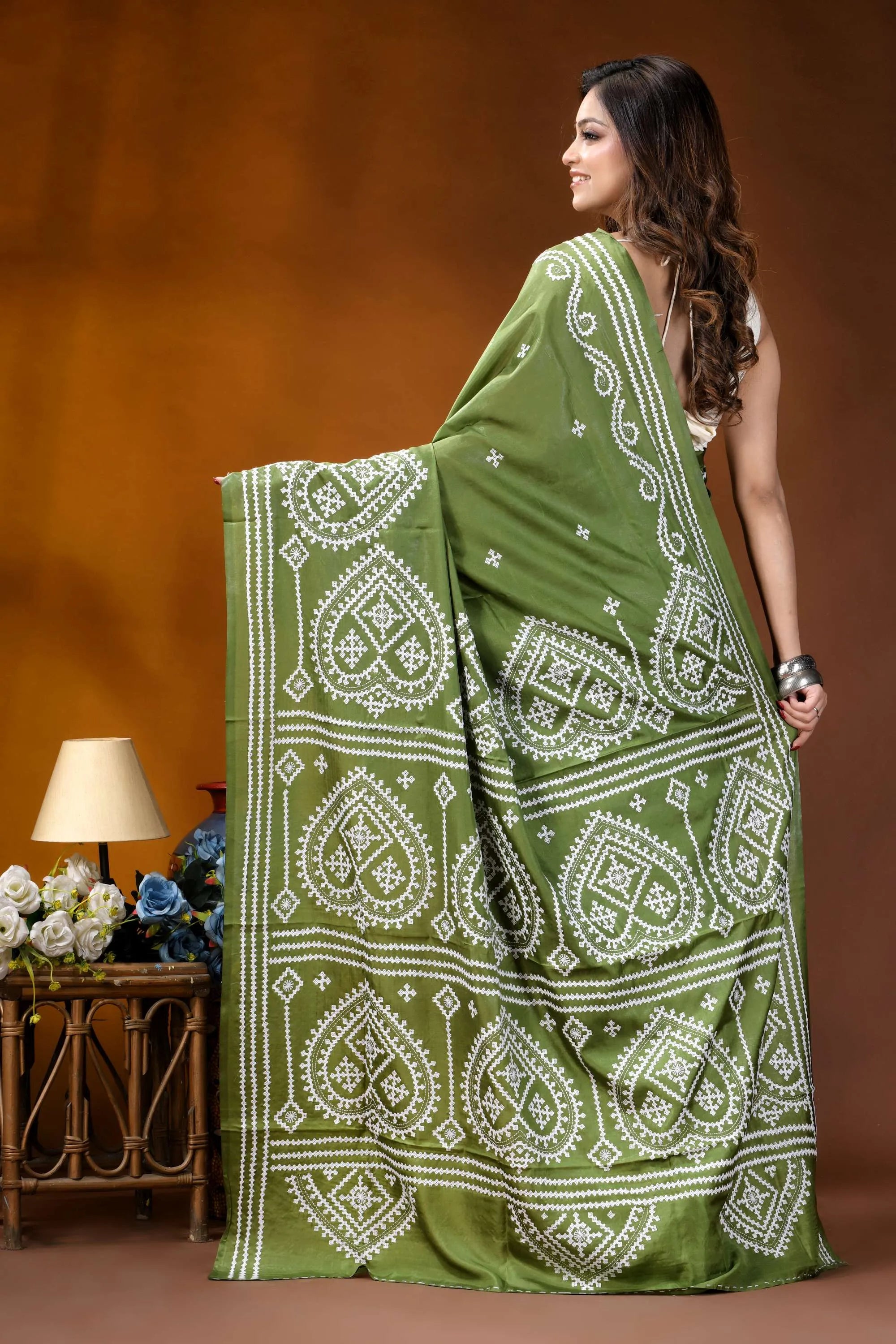 Leaf green ethnic motif hand embroidered gujrati stitch silk saree woman wears vibrant olive green 5