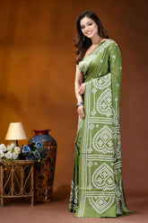 Leaf green ethnic motif hand embroidered gujrati stitch silk saree woman wears vibrant olive green 3