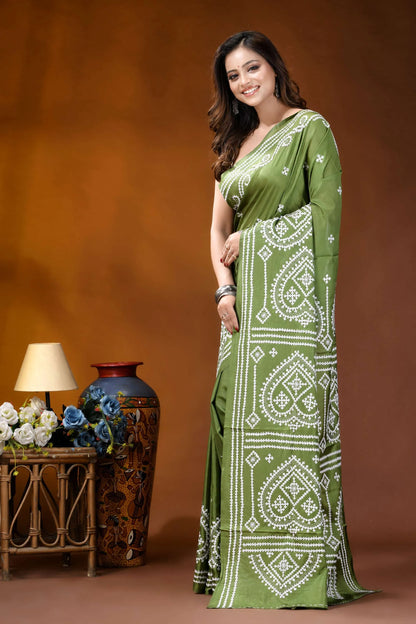 Leaf green ethnic motif hand embroidered gujrati stitch silk saree woman wears vibrant olive green 3