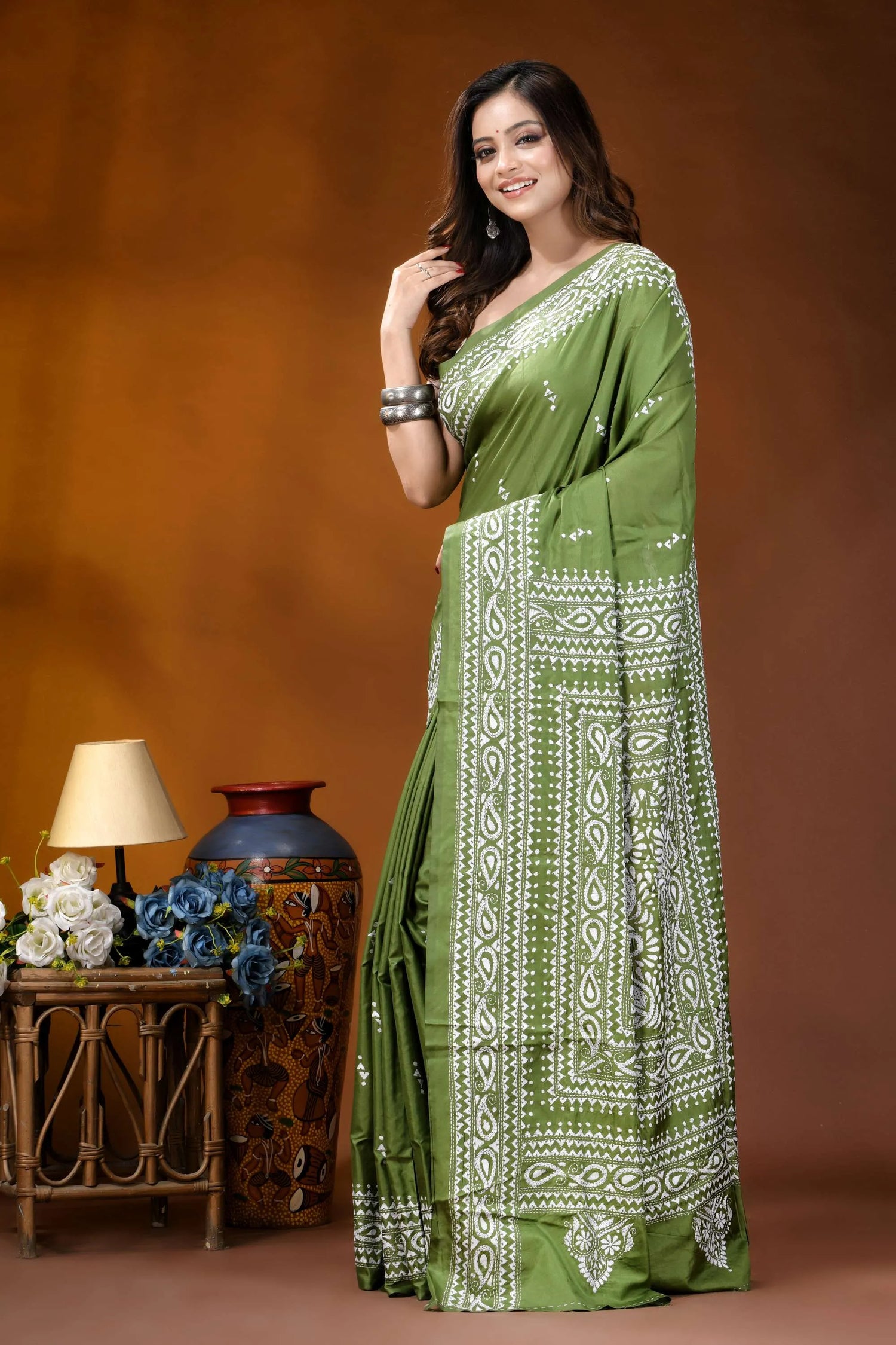 Leaf green paisley design hand embroidery silk kantha stitch saree woman wears vibrant olive green 3