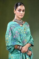 Light sea green folk art handcrafted silk kantha stitch saree woman wears teal-colored intricately embroidered 2