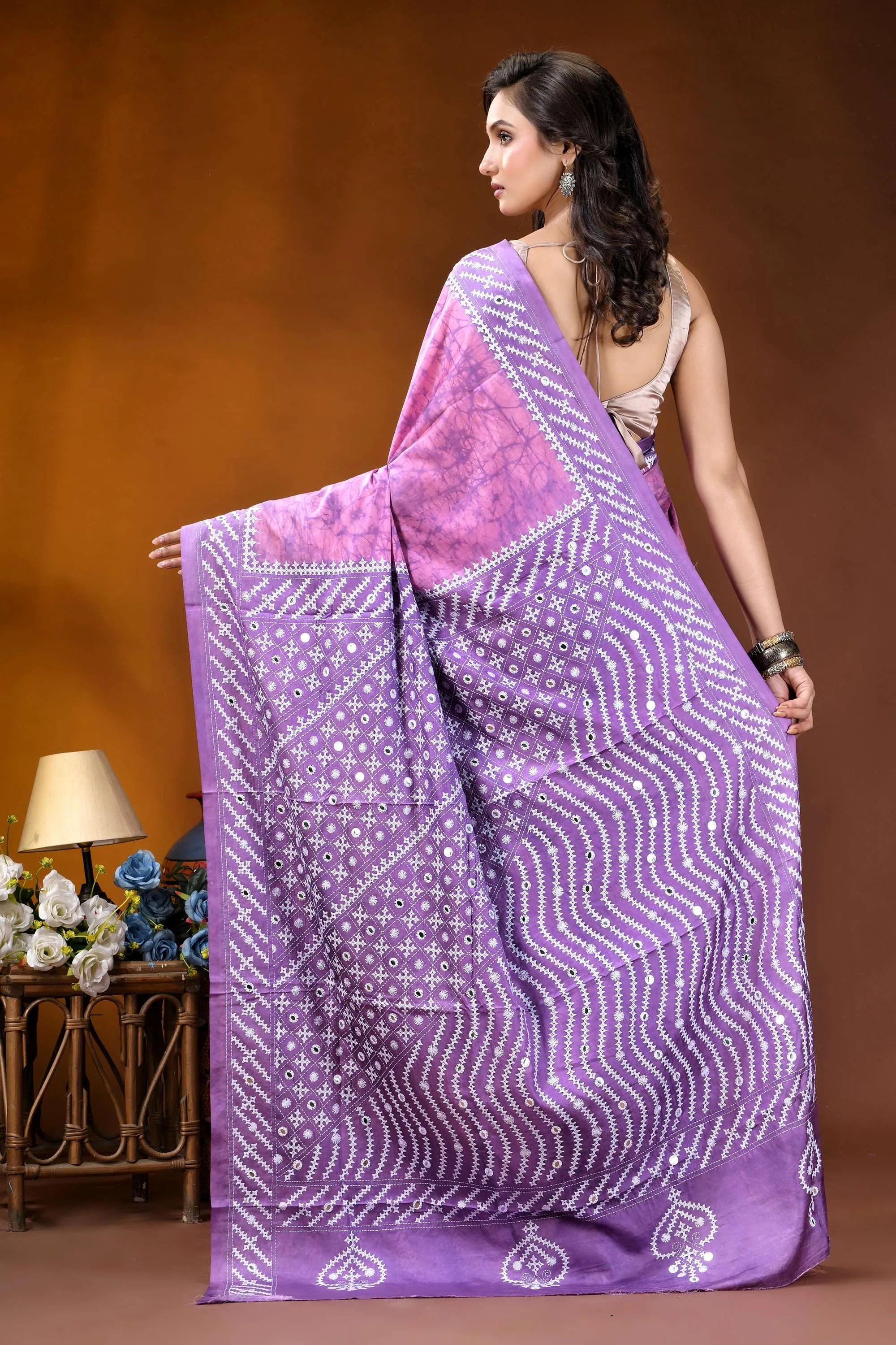 Mirror work geometric pattern hand batik gujarati stitch pink lavender dyed silk saree woman wears vibrant purple saree