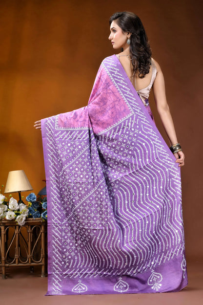 Mirror work geometric pattern hand batik gujarati stitch pink lavender dyed silk saree woman wears vibrant purple saree