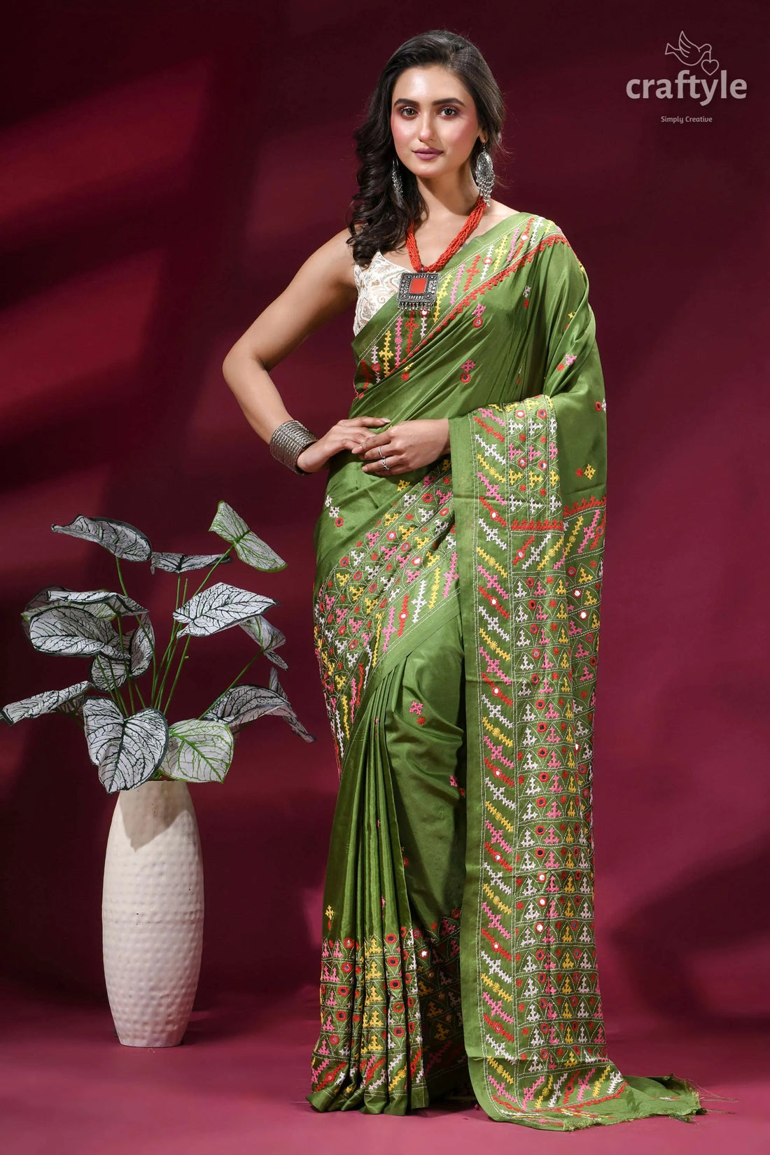 Moss green silk saree with multicolor kutch embroidery - mirror work woman wears vibrant olive green 1