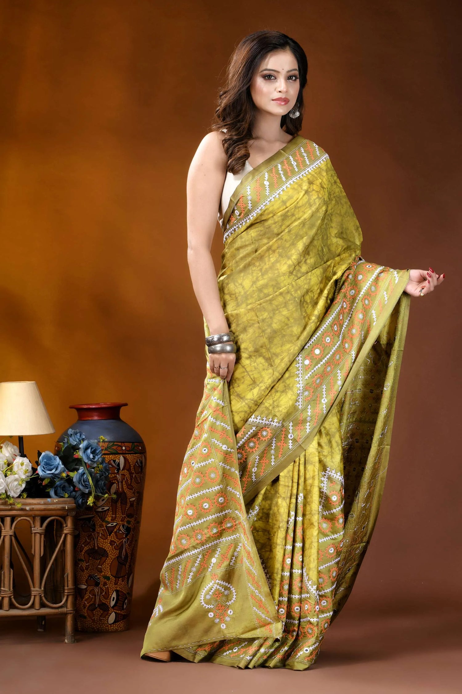 Naples yellow mirror work gujrati stitch dyed silk saree with ethnic hand batik design woman wears vibrant olive-green