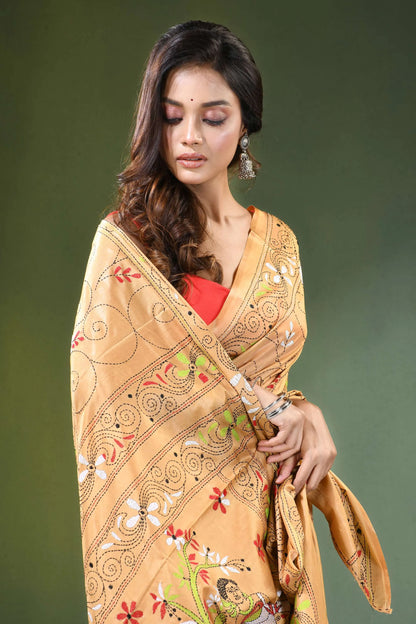 Peach hand embroidered folk art motif kantha embroidery silk saree woman wears golden-yellow intricate 2