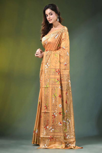 Peach hand embroidered folk art motif kantha embroidery silk saree woman wears golden-orange intricate 3