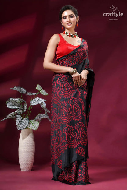 Red thread work handcrafted gujrati stitch silk saree in charcoal black woman wears black red paisley-patterned 5