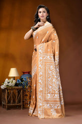 Sand brown white thread floral design handcrafted silk kantha saree woman wears golden-orange silk saree 3