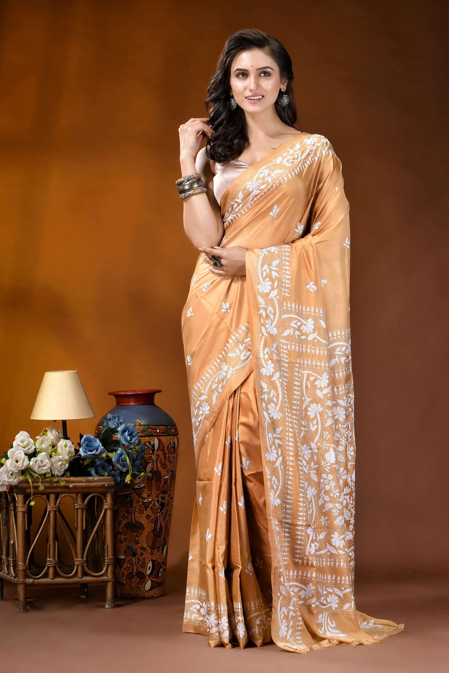 Sand brown white thread floral design handcrafted silk kantha saree woman wears golden-orange silk saree 6