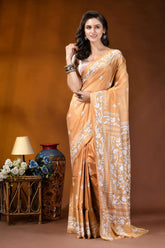 Sand brown white thread floral design handcrafted silk kantha saree woman wears golden-orange silk saree 6