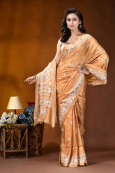 Sand brown white thread floral design handcrafted silk kantha saree woman wears peach-colored silk saree 4