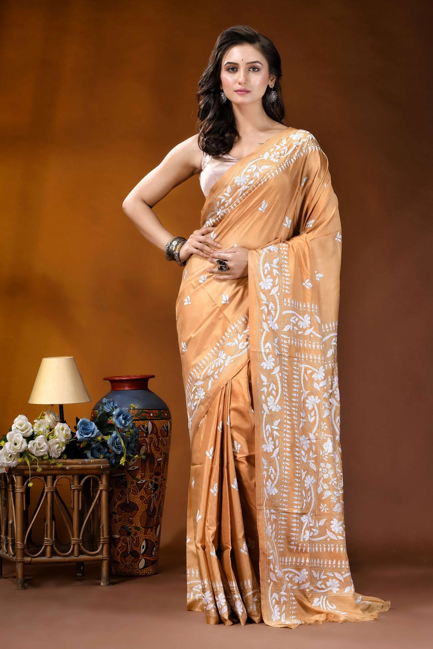 Sand brown white thread floral design handcrafted silk kantha saree woman wears golden-orange silk saree 1