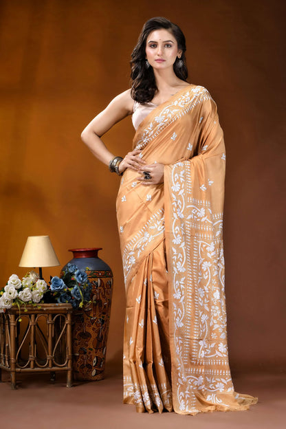 Sand brown white thread floral design handcrafted silk kantha saree woman wears golden-orange silk saree 1